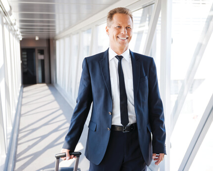 Man In Suit Walking Past Windows